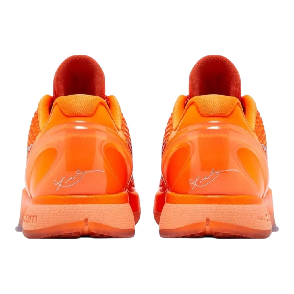 Pair of bright orange sneakers with a visible brand logo on a white background