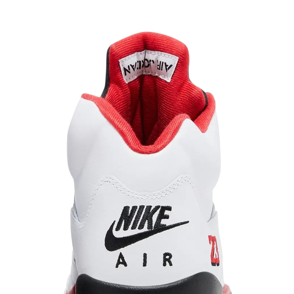 White Nike Air sneaker with red interior on a white background