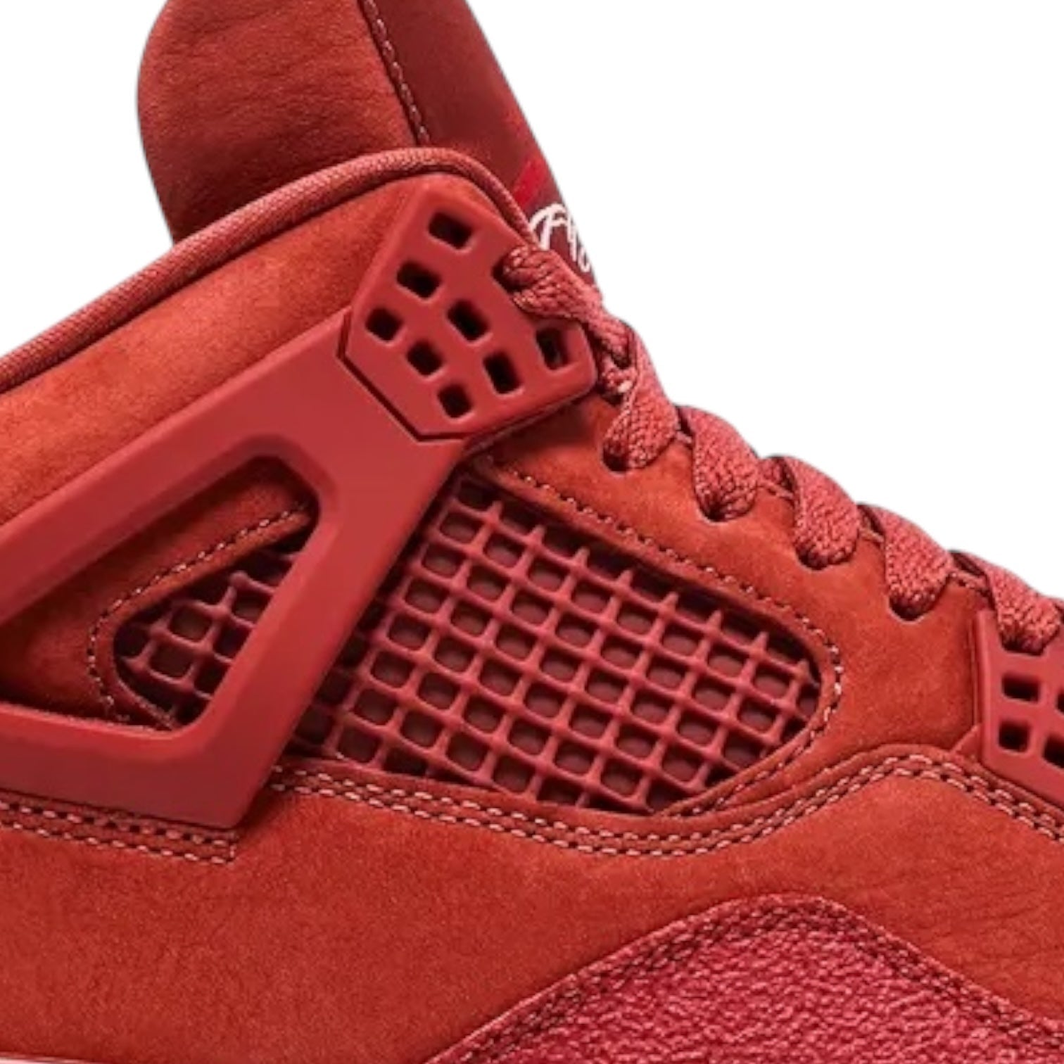 Close-up of a red sneaker with a textured sole on a white background