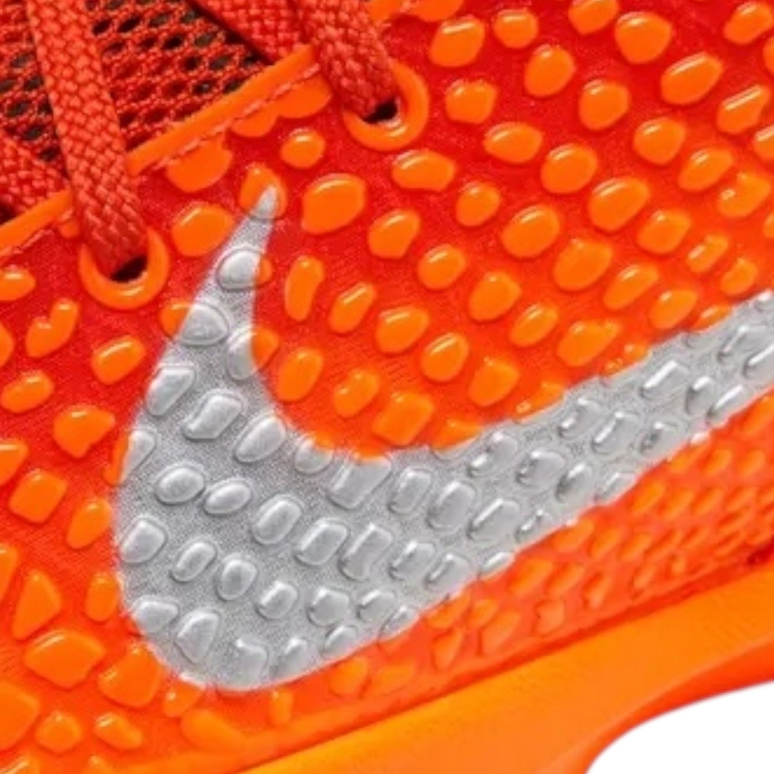 Close-up of orange athletic shoe with Nike logo on sole