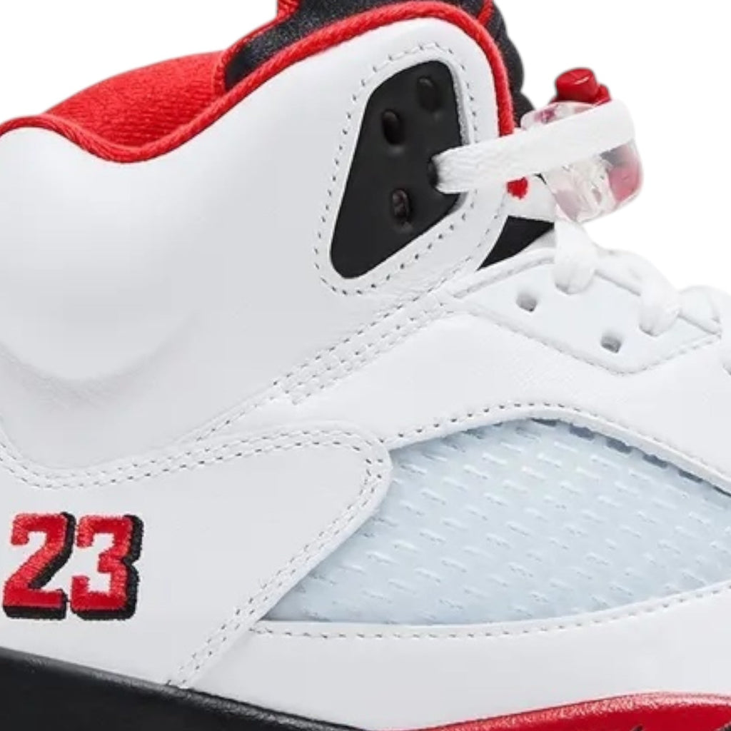White sneaker with red and black accents, featuring the number 23.