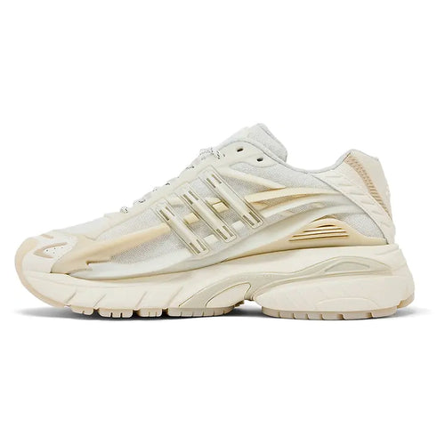 A single low-top athletic sneaker shown in a side profile on a clean white background. The shoe features a cream and off-white mesh upper with metallic gold synthetic overlays, matching gold laces, and a chunky cream midsole and outsole.